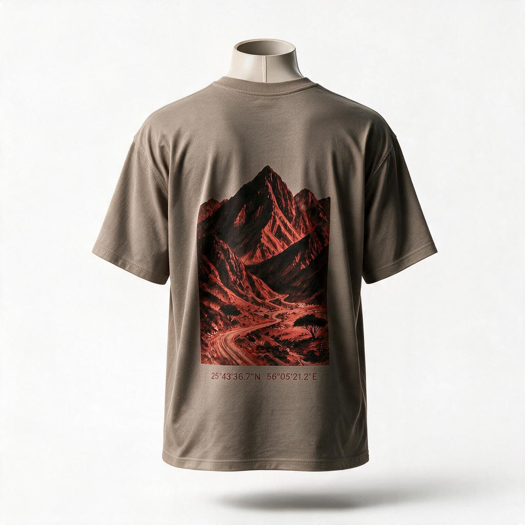 Hajar Mountains Tee, oversized fit, back — the red rock of the Hajar Mountains